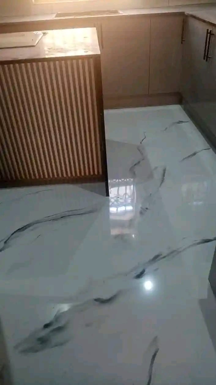 Modern kitchen with reflective metallic epoxy floor